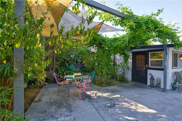 an aerial view of a residential houses with outdoor space and trees
