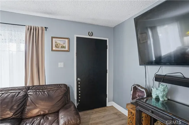 a view of a hallway with wooden floor and closet