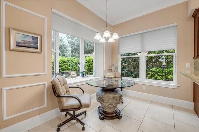 a living room with patio furniture and a large window