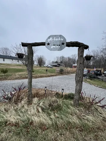 a front view of a house with outdoor seating