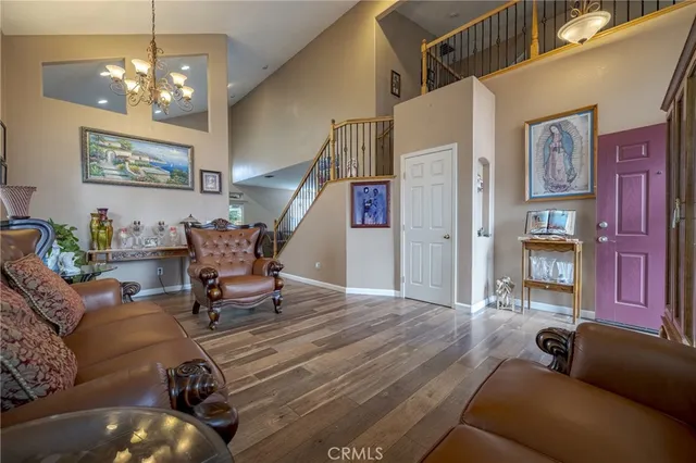a living room with furniture and a chandelier
