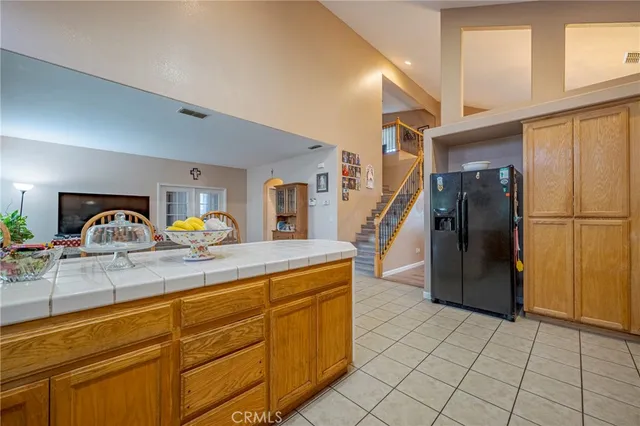 a kitchen with stainless steel appliances granite countertop a refrigerator and a sink