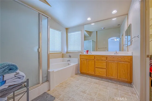 a bathroom with a tub sink and mirror