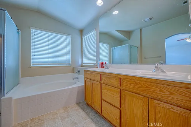 a bathroom with a tub sink and mirror