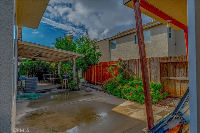 a view of a patio with a table and chairs under an umbrella