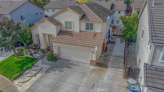 a view of a house with a yard and potted plants