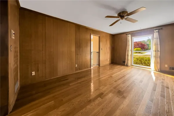 a living room with furniture and a large window with outer view