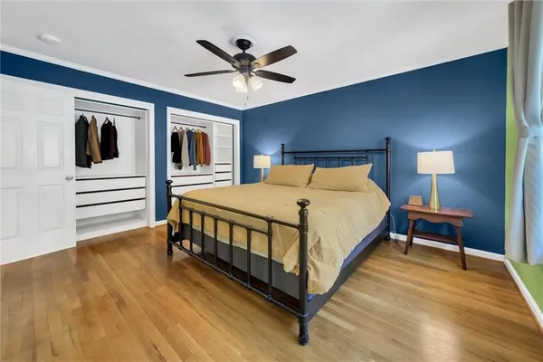 a bedroom with a bed and ceiling fan