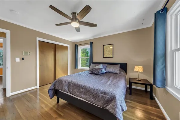 a bedroom with a bed and a large window