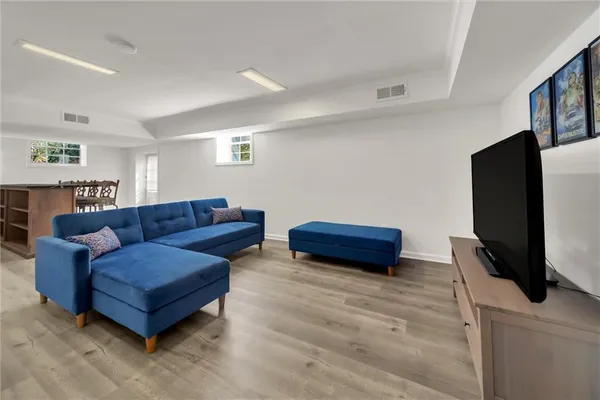 a living room with furniture and wooden floor