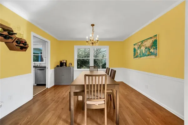 a view of a dining room with furniture and a chandelier