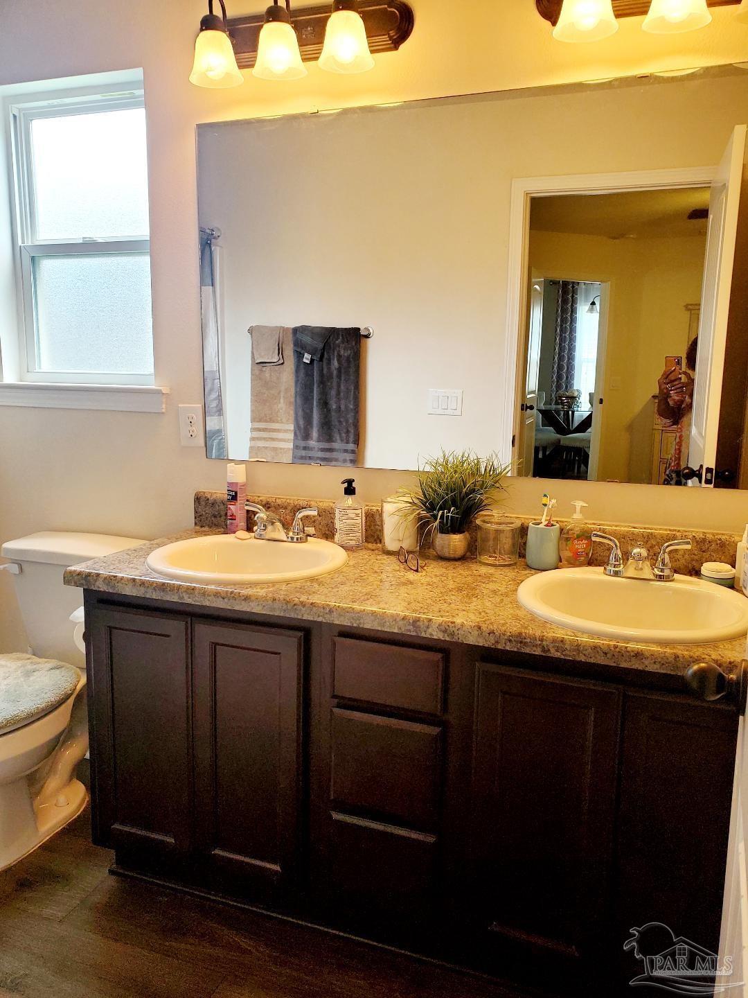 5845 Fairlands Road Milton, FL 32583 - Photo 12 of 21 a bathroom with a double vanity sink and a mirror