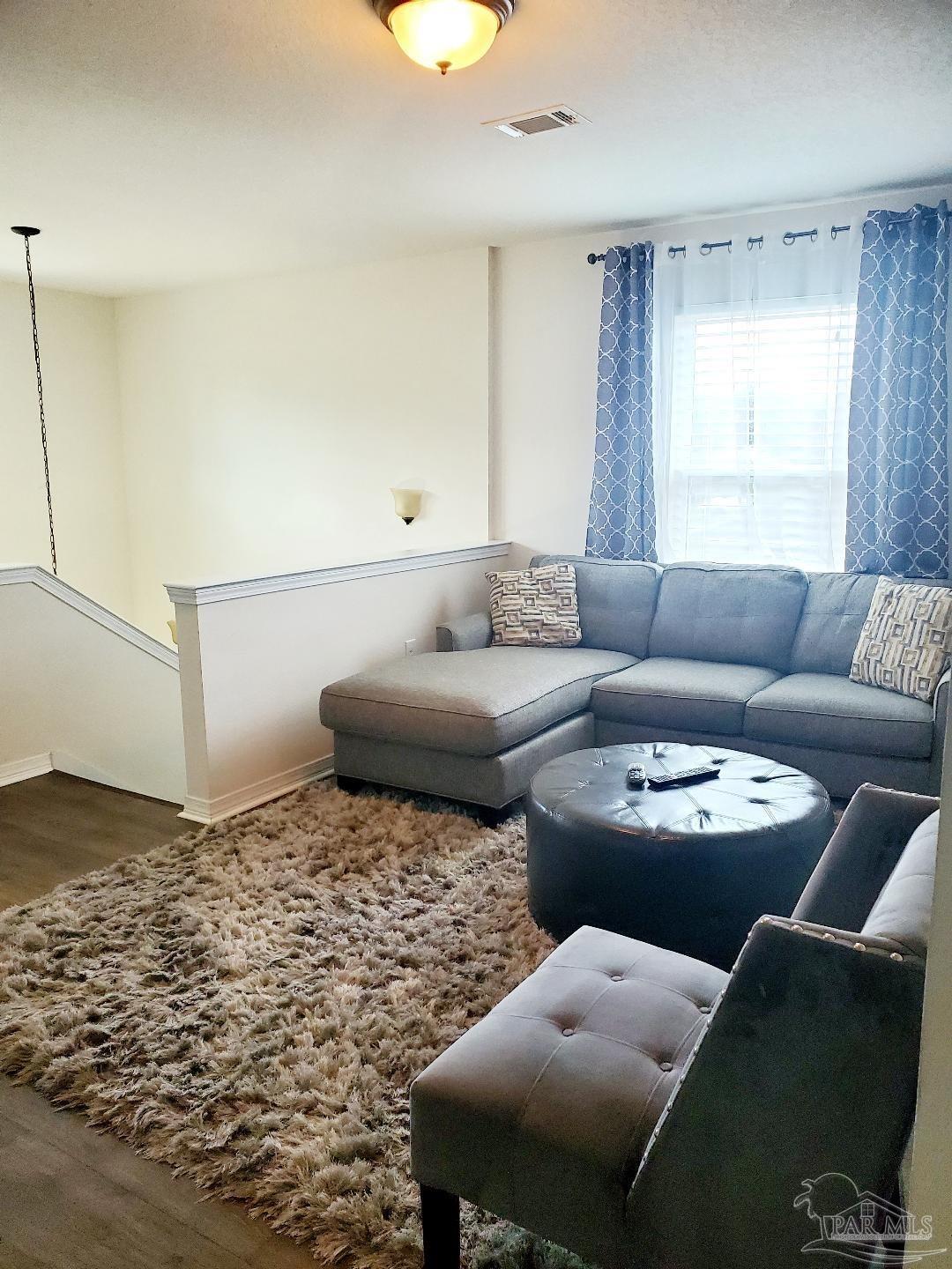 5845 Fairlands Road Milton, FL 32583 - Photo 15 of 21 a living room with furniture and a couch