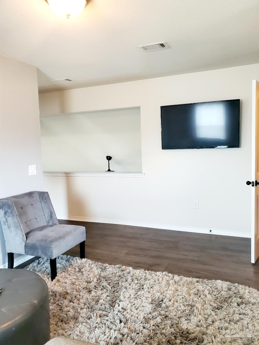 5845 Fairlands Road Milton, FL 32583 - Photo 16 of 21 a living room with furniture and a flat screen tv