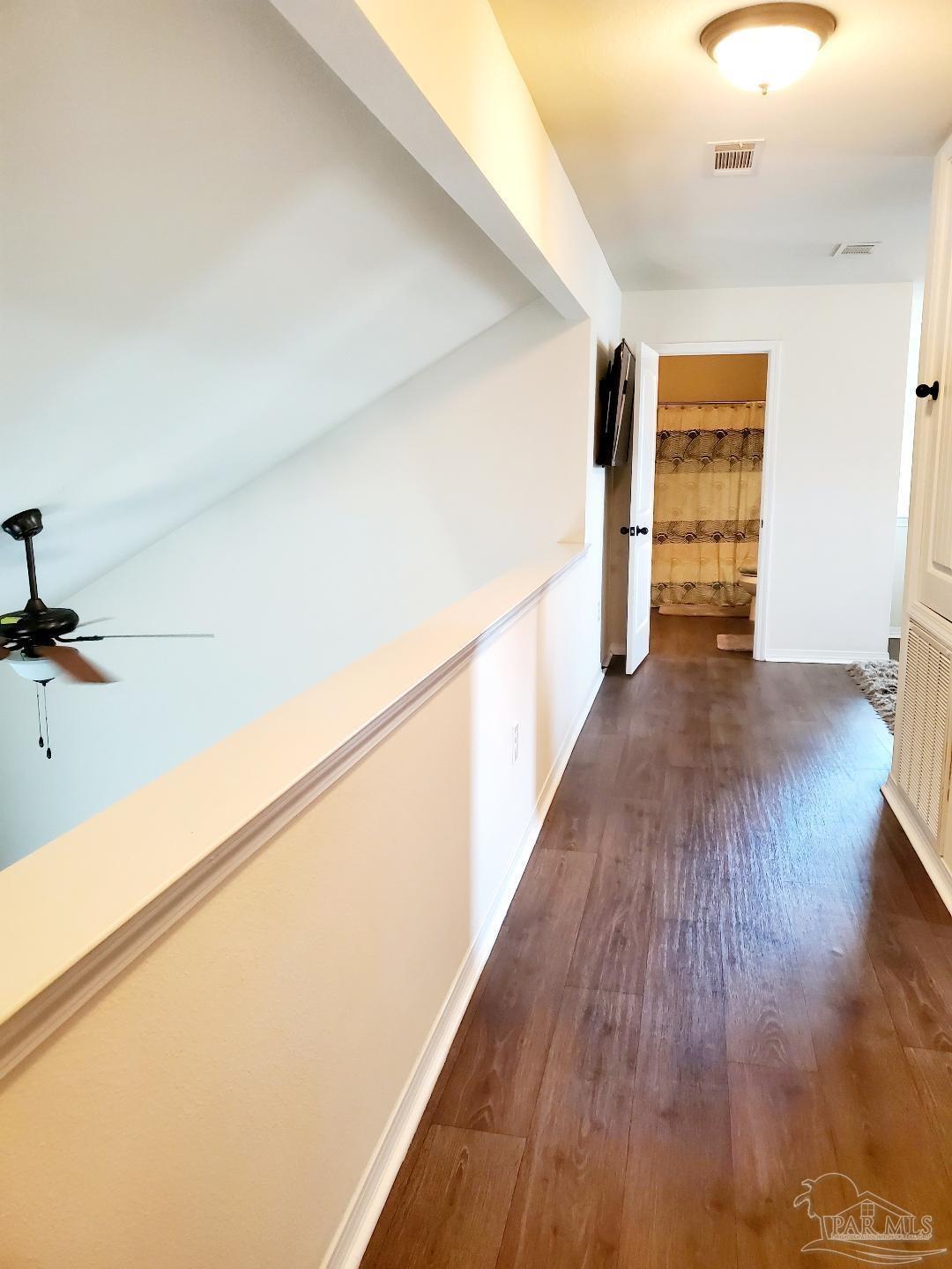 5845 Fairlands Road Milton, FL 32583 - Photo 18 of 21 a view of a hallway with wooden floor