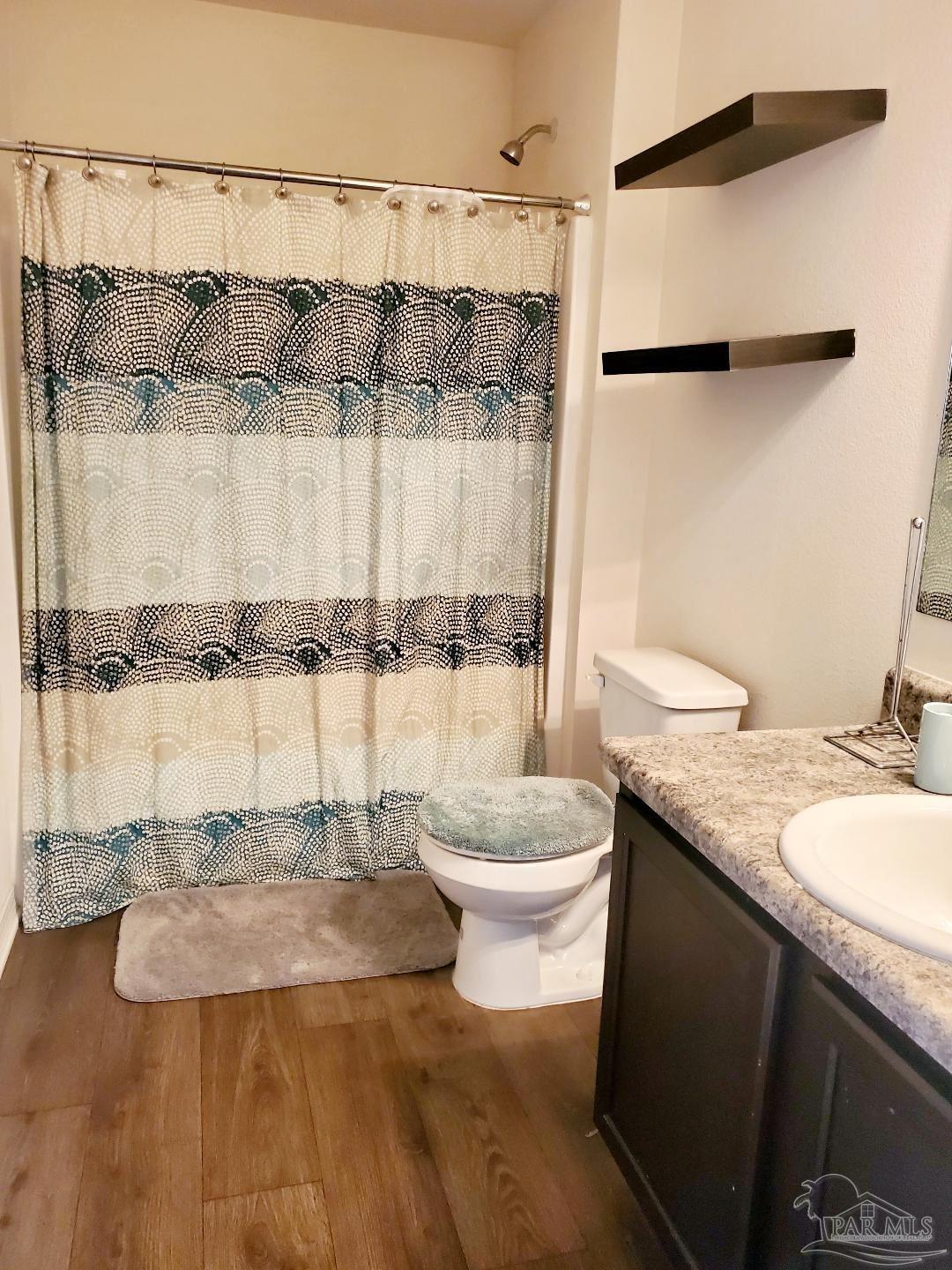 5845 Fairlands Road Milton, FL 32583 - Photo 19 of 21 a bathroom with a granite countertop sink and a mirror