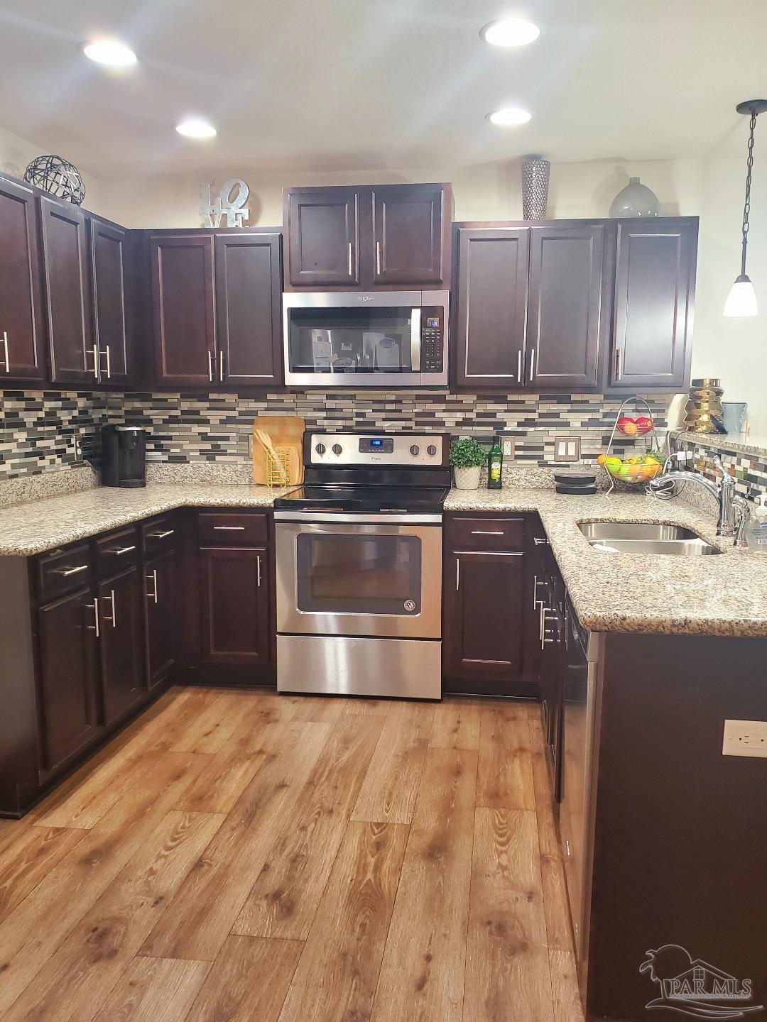 5845 Fairlands Road Milton, FL 32583 - Photo 8 of 21 a kitchen with stainless steel appliances granite countertop a stove a sink dishwasher and a refrigerator
