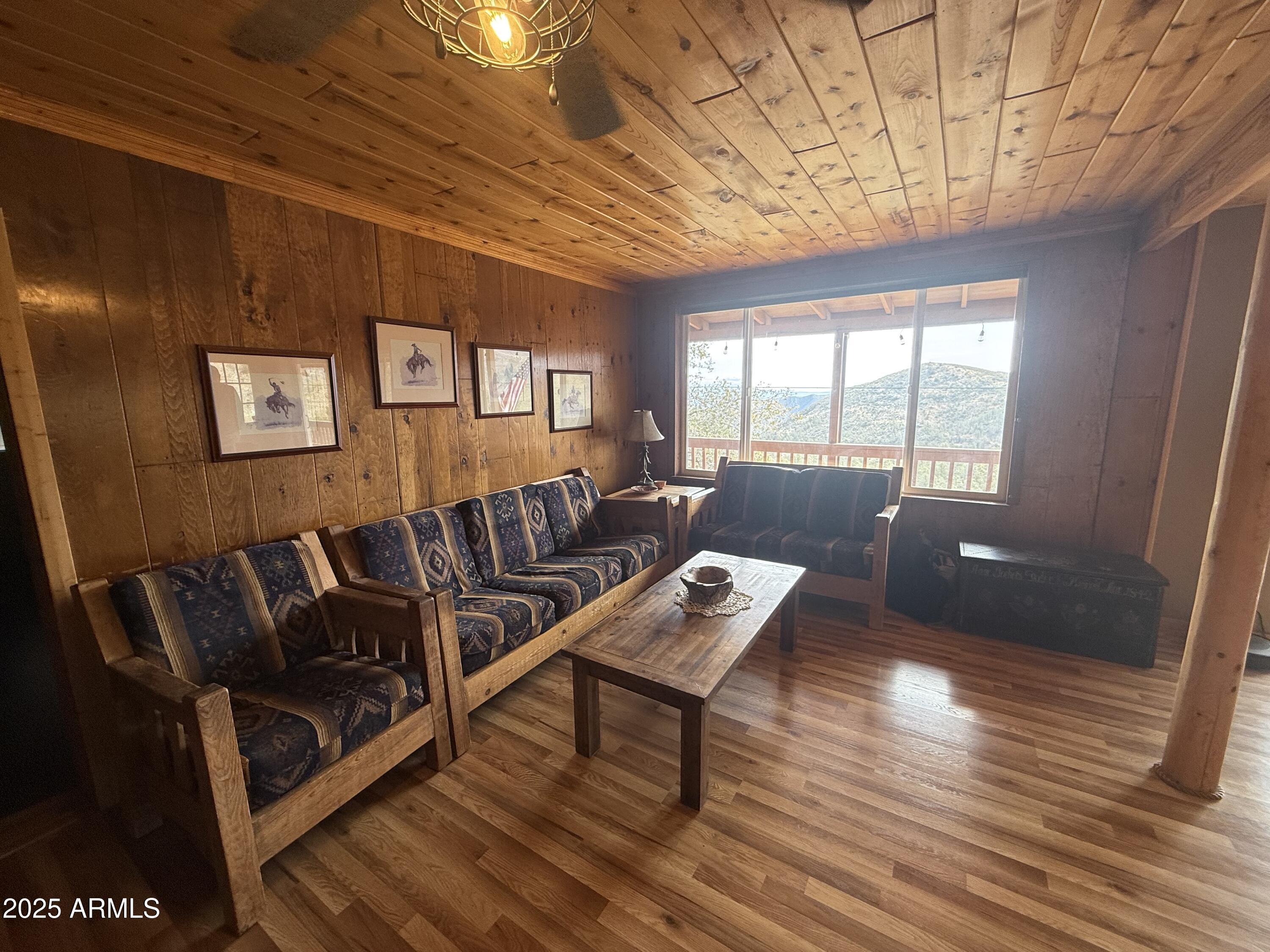 23442 Manzanita Road Crown King, AZ 86343 - Photo 22 of 41 a living room with furniture and a wooden floor