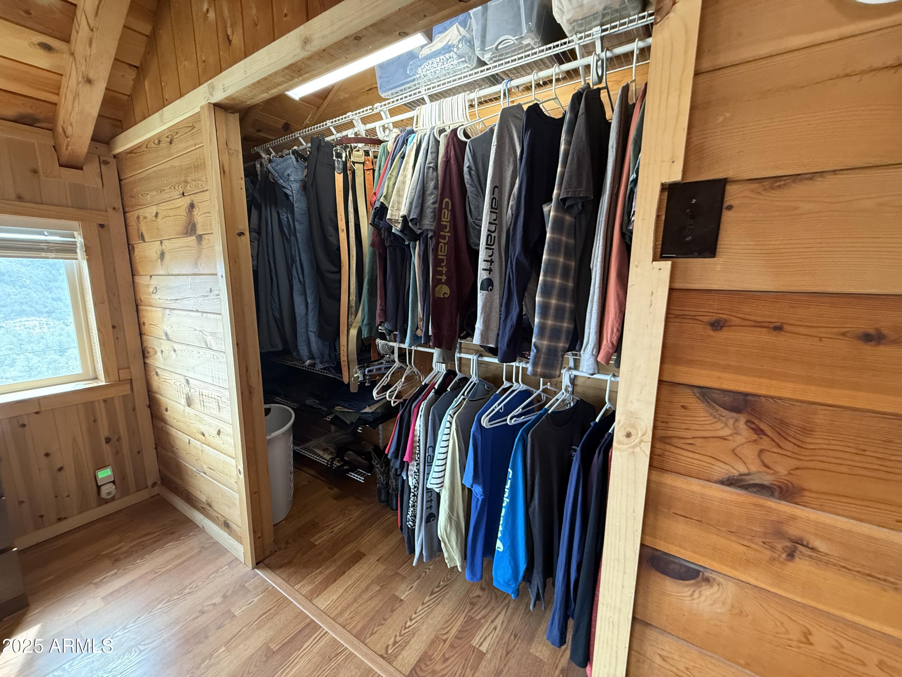 23442 Manzanita Road Crown King, AZ 86343 - Photo 28 of 41 a view of walk in closet with clothes and shoes