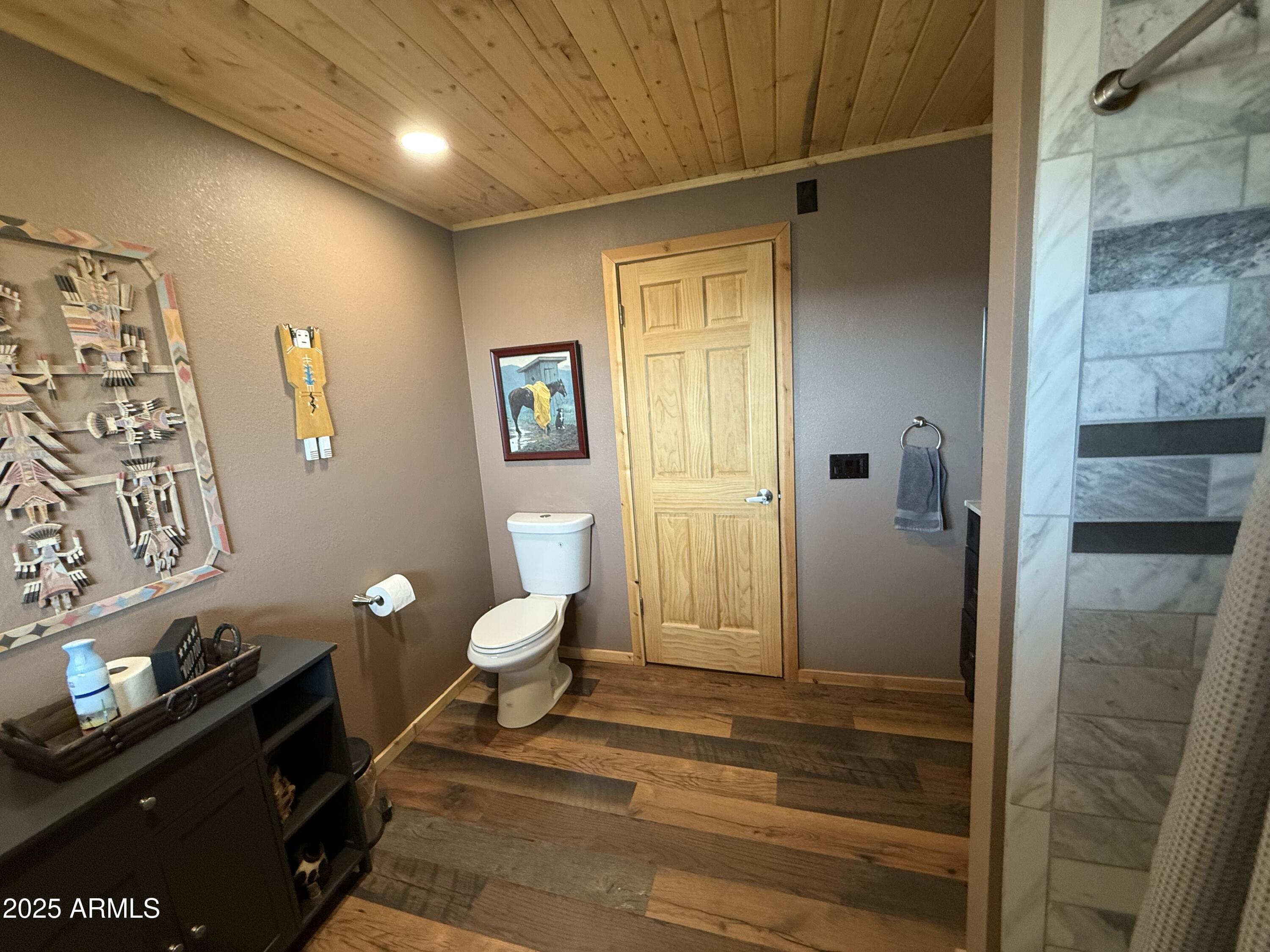 23442 Manzanita Road Crown King, AZ 86343 - Photo 41 of 41 a spacious bathroom with a granite countertop sink a toilet and shower