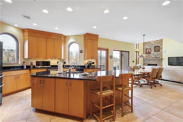 a large dining hall with stainless steel appliances a sink and a large window