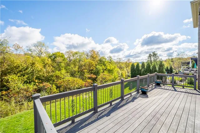a view of a balcony with wooden floor & fence