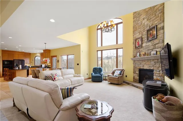 a living room with furniture fireplace and a large window