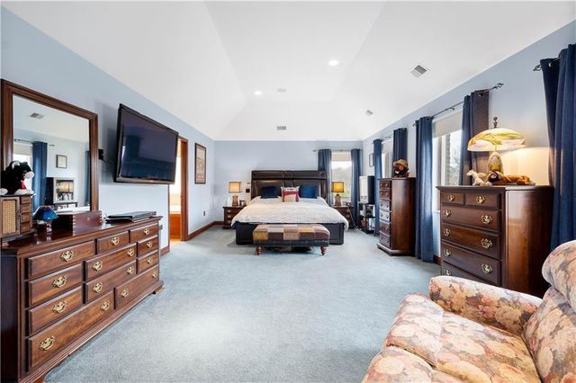 a bedroom with furniture and a flat screen tv