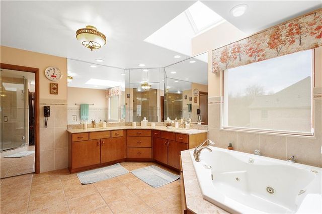 a large bathroom with a large tub and sink