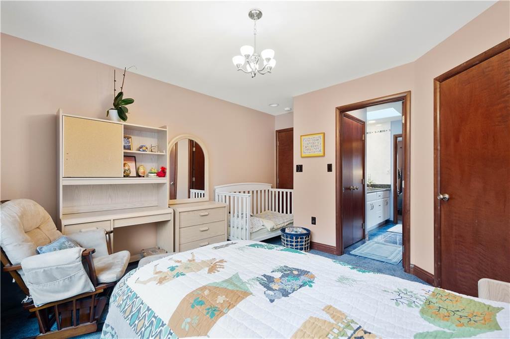 108 Saddle Ridge Drive Oakdale, PA 15071 - Photo 34 of 50 a bedroom with a bed and a chandelier