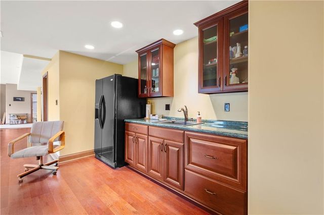 a kitchen with granite countertop a refrigerator and a sink