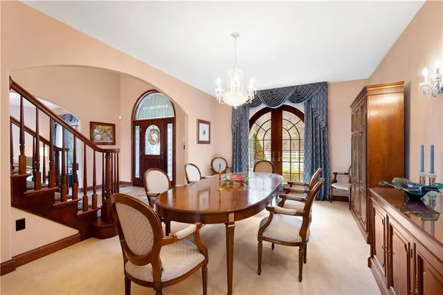 a view of a dining room with furniture and a chandelier