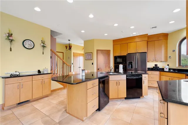 a large kitchen with stainless steel appliances lots of counter space and breakfast area