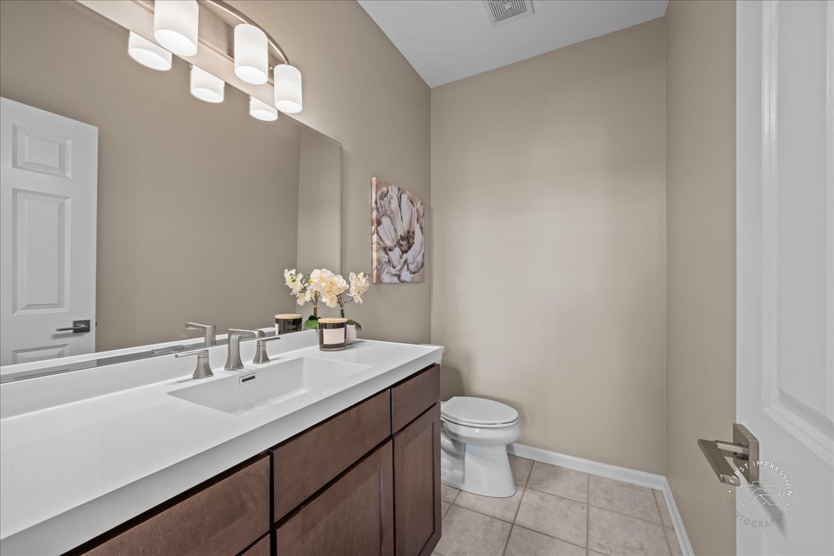 N160 Yates Place Geneva, IL 60134 - Photo 16 of 30 a bathroom with a sink a toilet and a mirror