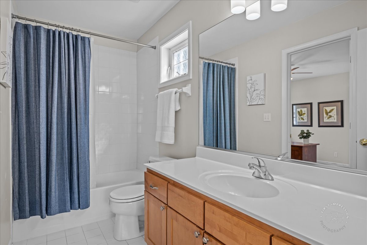 N160 Yates Place Geneva, IL 60134 - Photo 20 of 30 a bathroom with a granite countertop sink toilet a mirror and shower