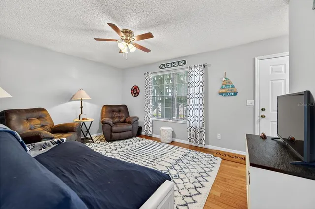 a bedroom with furniture and a flat screen tv
