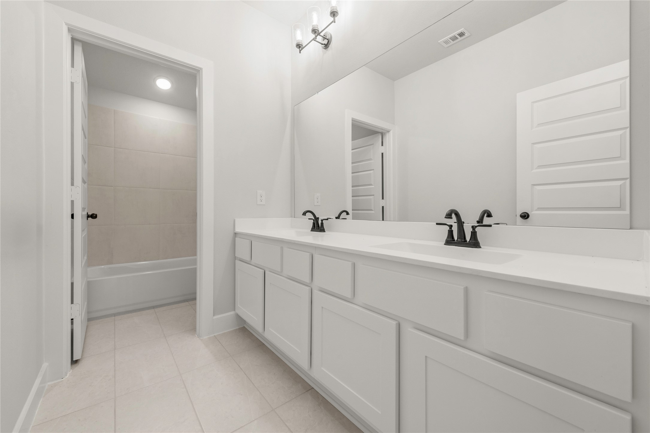 10950 Middle Rdg Drive Missouri City, TX 77459 - Photo 15 of 21 a bathroom with a double vanity sink mirror and bathtub
