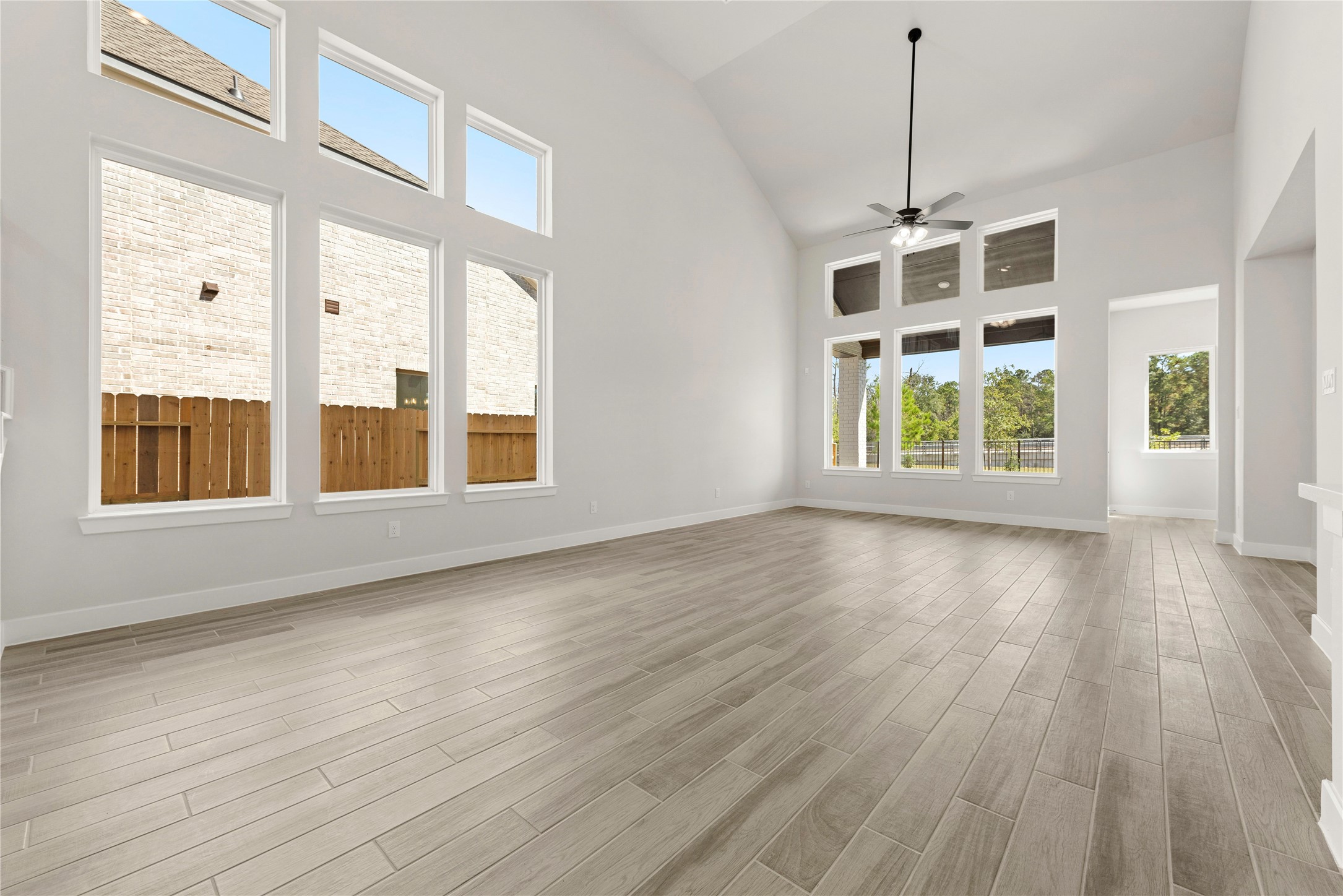 10950 Middle Rdg Drive Missouri City, TX 77459 - Photo 4 of 21 a view of an empty room with a window and wooden floor
