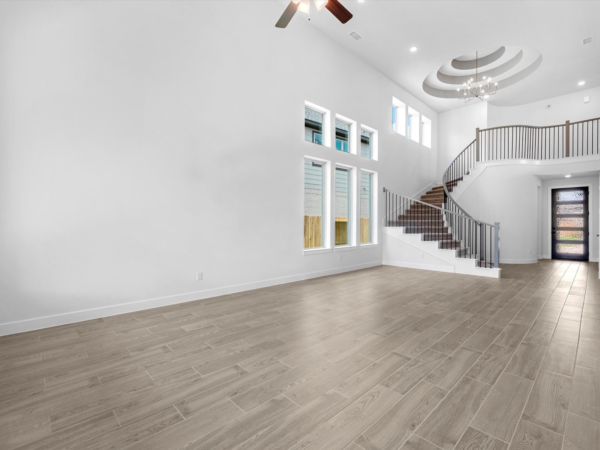 10950 Middle Rdg Drive Missouri City, TX 77459 - Photo 7 of 28 an empty room with wooden floor and windows