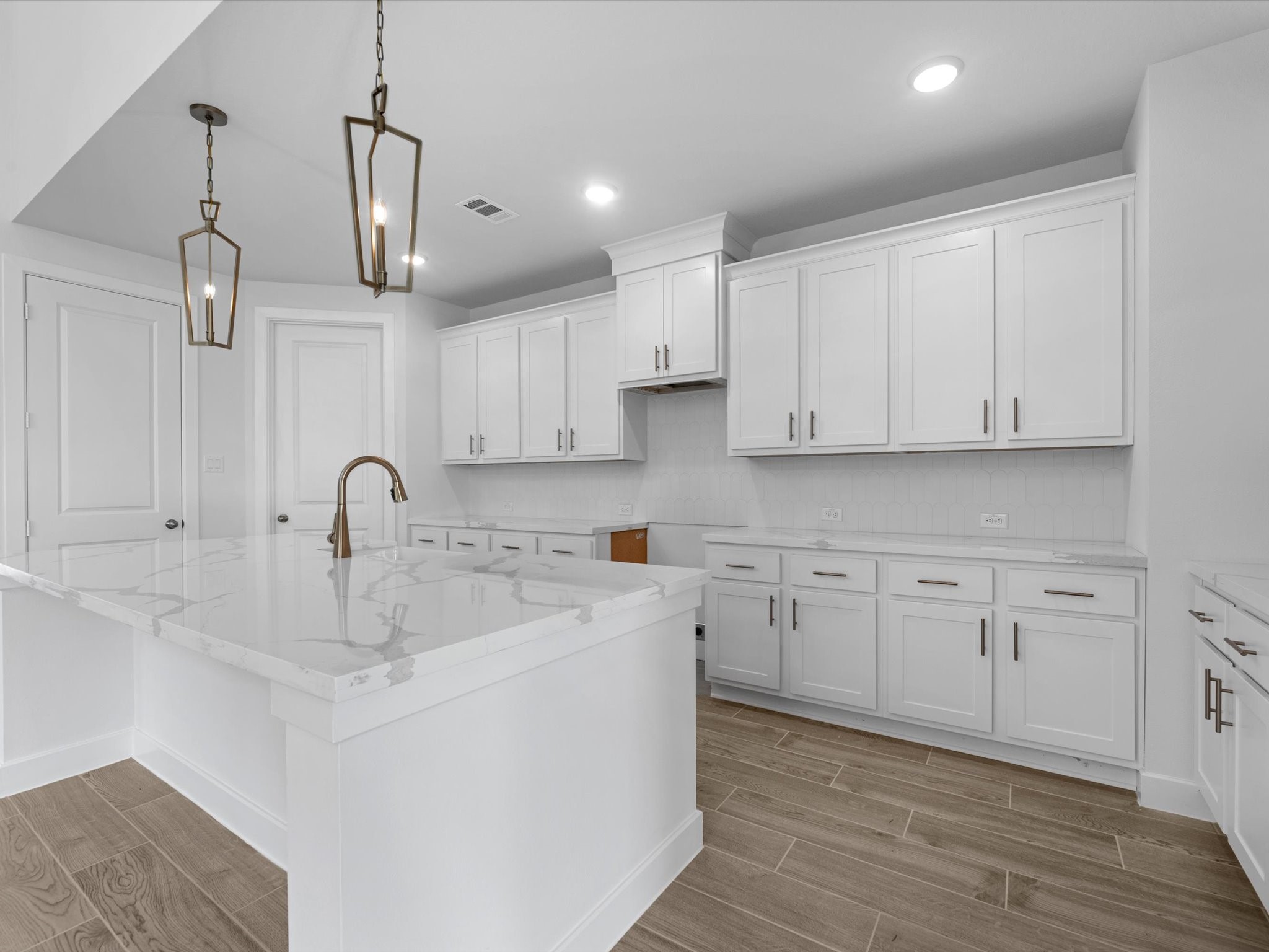 10950 Middle Rdg Drive Missouri City, TX 77459 - Photo 10 of 28 a kitchen with stainless steel appliances granite countertop a sink a stove and white cabinets with wooden floor