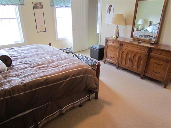 52 Vista Circle Rutland, MA 01543 - Photo 12 of 30 a bedroom with a bed a mirror and dresser