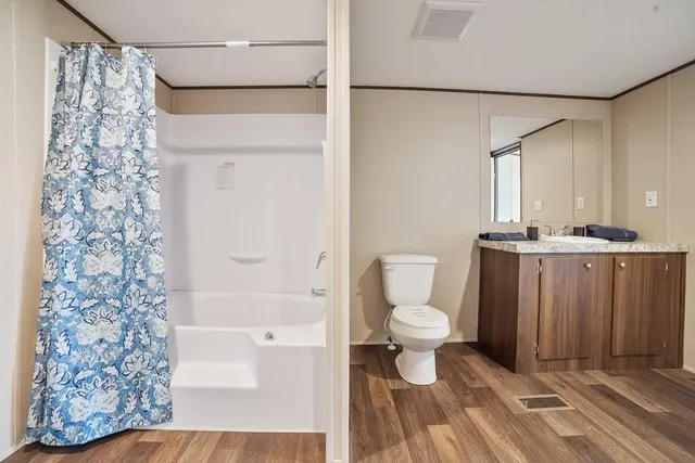 a bathroom with a toilet and a shower