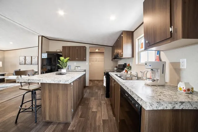 a kitchen with a sink a stove and chairs