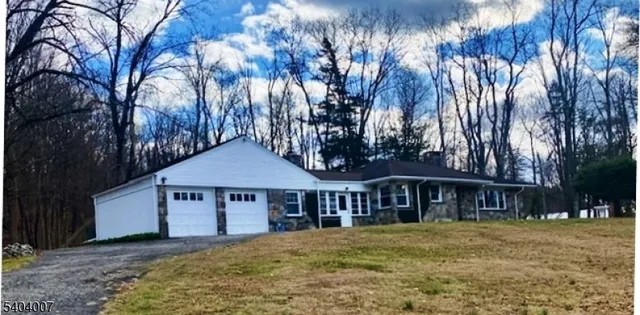 a view of house with backyard and seating space