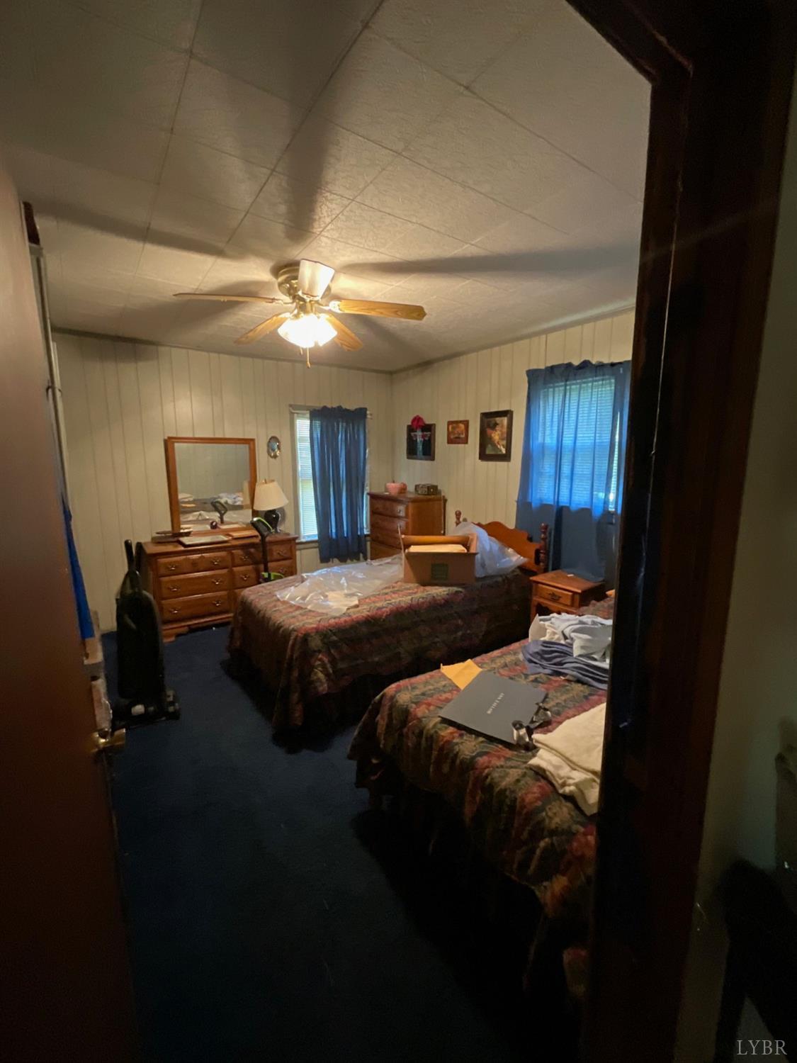 2851 Timber Ridge Road Bedford, VA 24523 - Photo 2 of 2 a bedroom with a bed and a chandelier