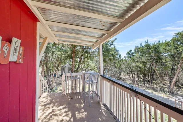 a view of a porch with wooden stairs and floor
