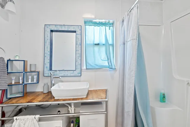 a bathroom with a bathtub and shower