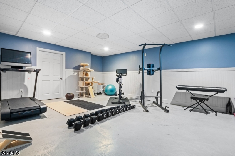 99 East Lindsley Road Cedar Grove, NJ 07009 - Photo 38 of 41 a room with gym equipment and a table