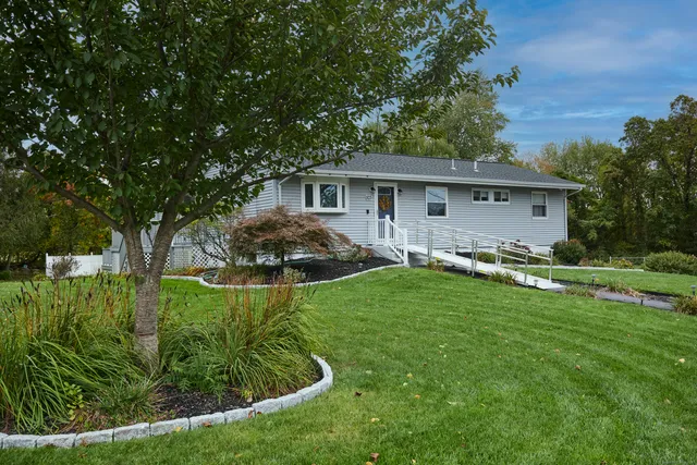 a front view of house with yard and green space