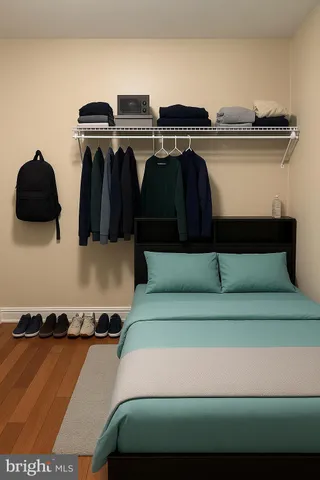 a bedroom with a bed and wooden floor